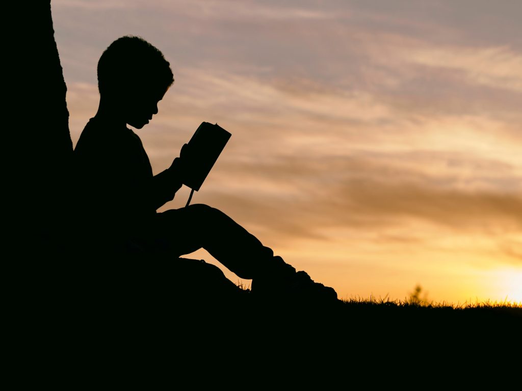 Profile of a child reading a book