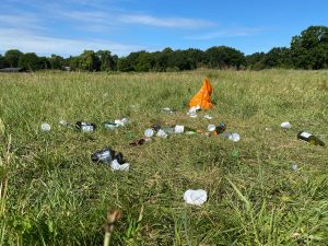 Discarded litter in a green meadow
